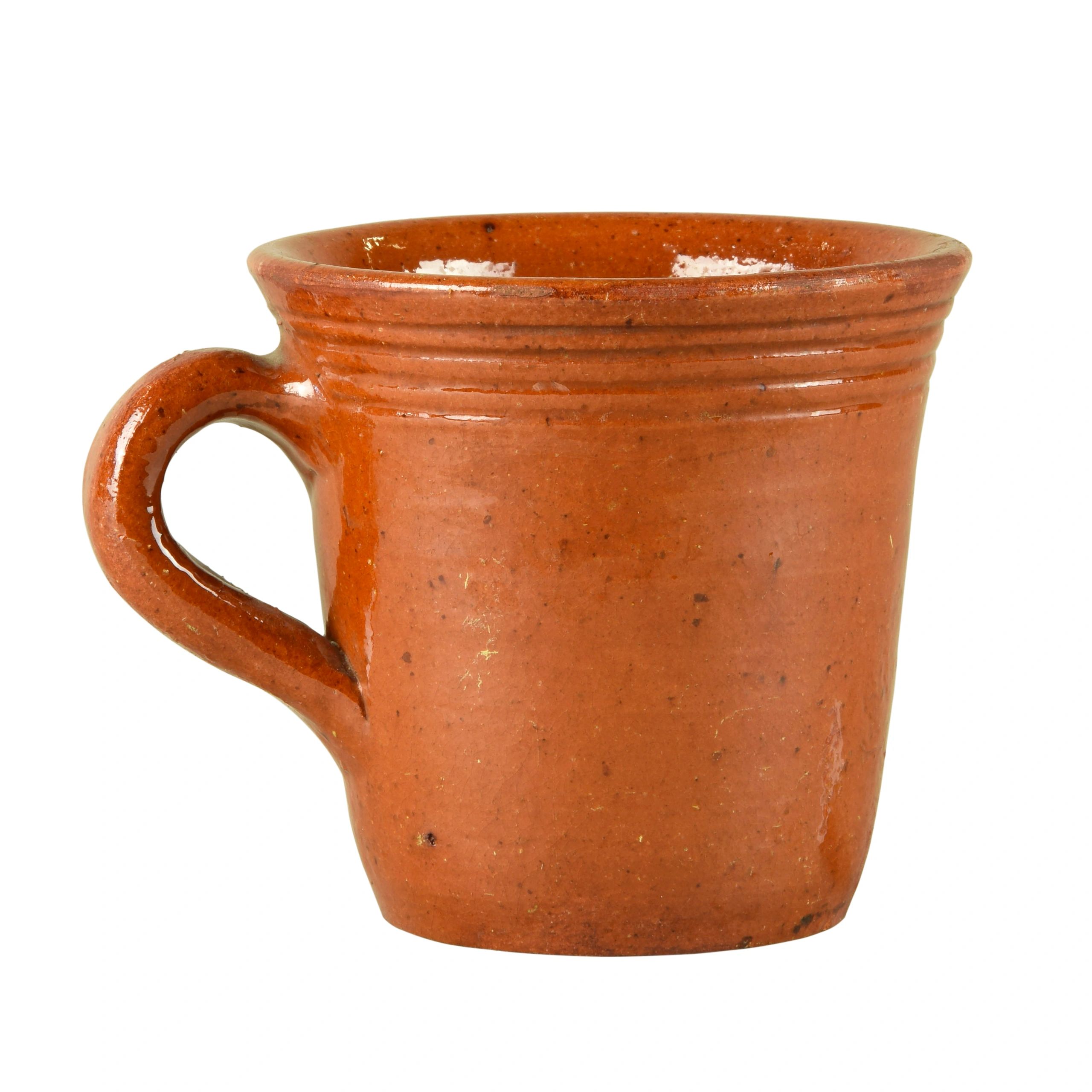 Brown clay mug on a clean white background