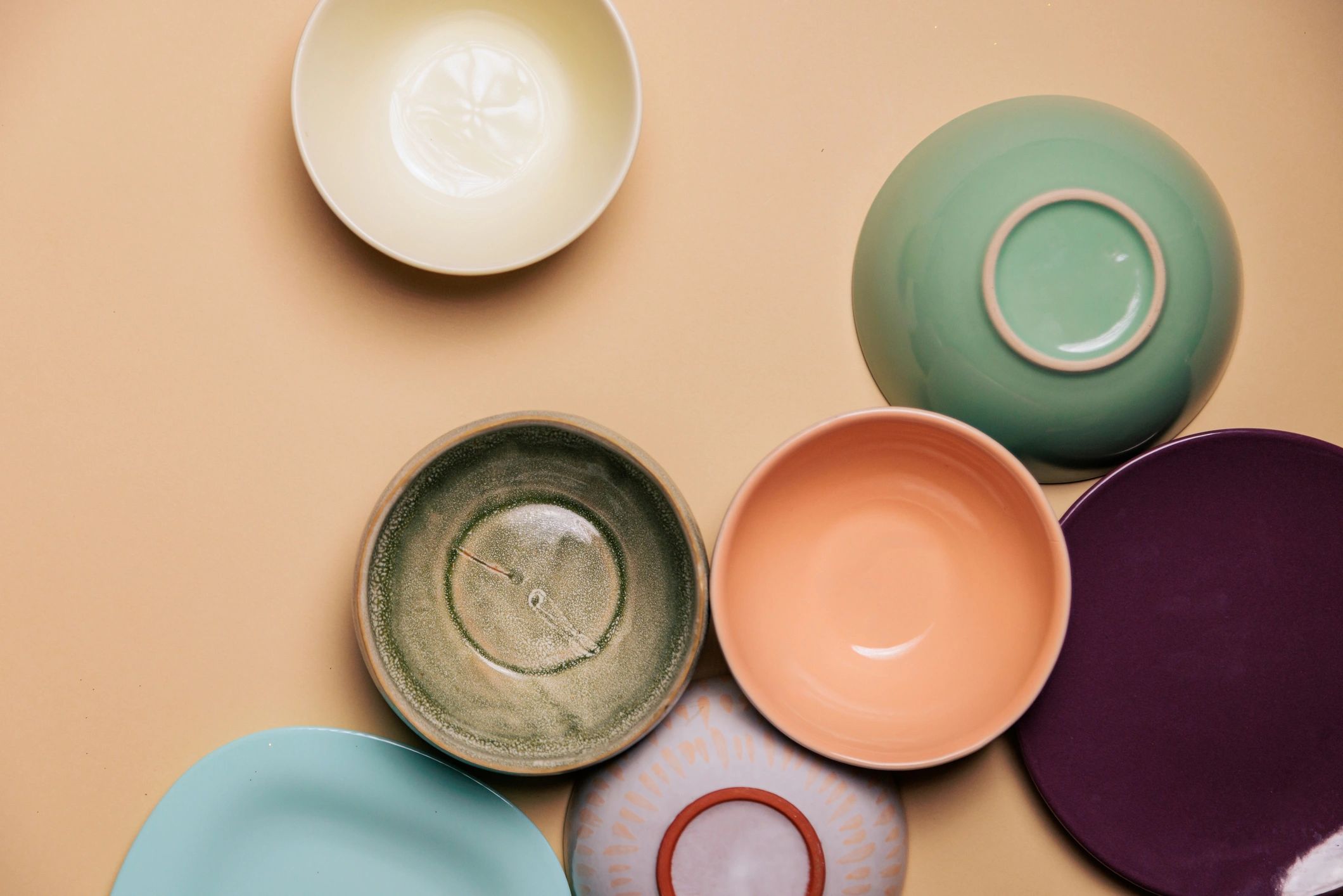 Colorful handmade ceramic bowls arranged on a neutral background